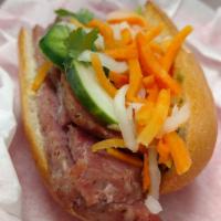 Grilled Cured Pork Banh Mi · Sweet and savory pork patties. Served with homemade aioli, cilantro, cucumber, jalapeno, pic...