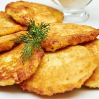 Potato Pancakes · Our fried potato pancakes served with sour cream & applesauce.