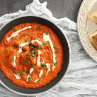 Butter Chicken  · Charbroiled chicken simmered in a creamy tomato sauce served with basmati rice and garlic na...