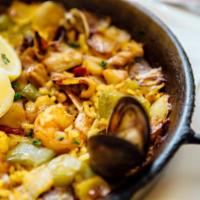 Pella de Pescado y Mariscosa · Seafood paella with prawns calamari, mussels, clams, and fresh fish on a bed of saffron rice.