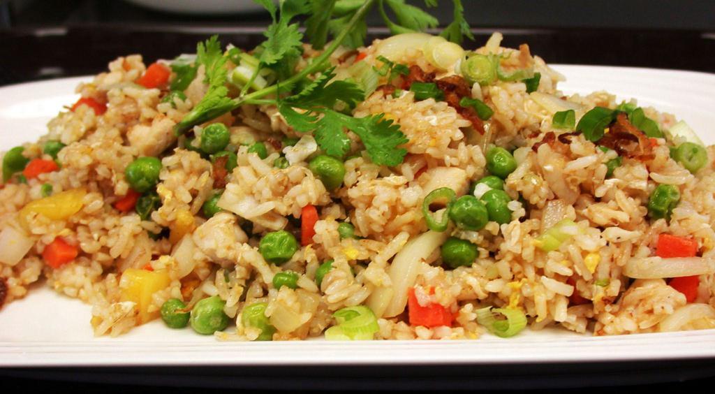 Fried Rice - Cơm Chiên · In this dish delicious dish there are white steamed rice, peas, carrots, onions, garlic, eggs, your choices of beef, pork, chicken or shrimp, all stir fried together.
