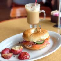 Bagel and Lox Sandwich · A toasted bagel sandwich with cream cheese, smoked salmon, capers, onions, dill, sliced toma...