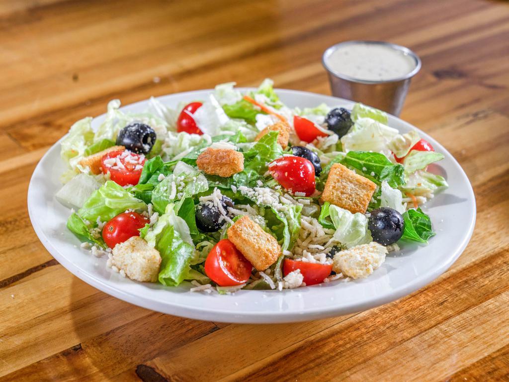 Caesar Salad · Small. Freshly cut romaine lettuce topped with Roma tomatoes, croutons, whole black olives, shredded Parmesan cheese, and creamy Caesar dressing.
