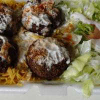 Falafel Over Rice · A Vegiterian delight, Falafel, Brown Rice, Salad topped with homemade Taziki sauce (White Sa...