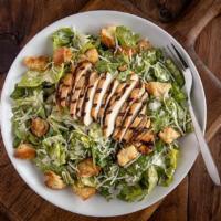 Caesar Salad · Romaine lettuce, grated cheese, and croutons tossed in our own home-made dressing.