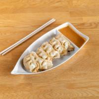 Pot Stickers · Six pieces. Pan-fried or steamed pork dumpling, served with panang curry sauce.