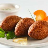 Kibbe · Mediterranean meatballs, prepared with fresh ground beef, bulgar, spices, onions & stuffed w...