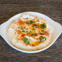 Hummus · Pureed chickpeas with a hint of garlic, lemon, herbs and extra virgin olive oil.