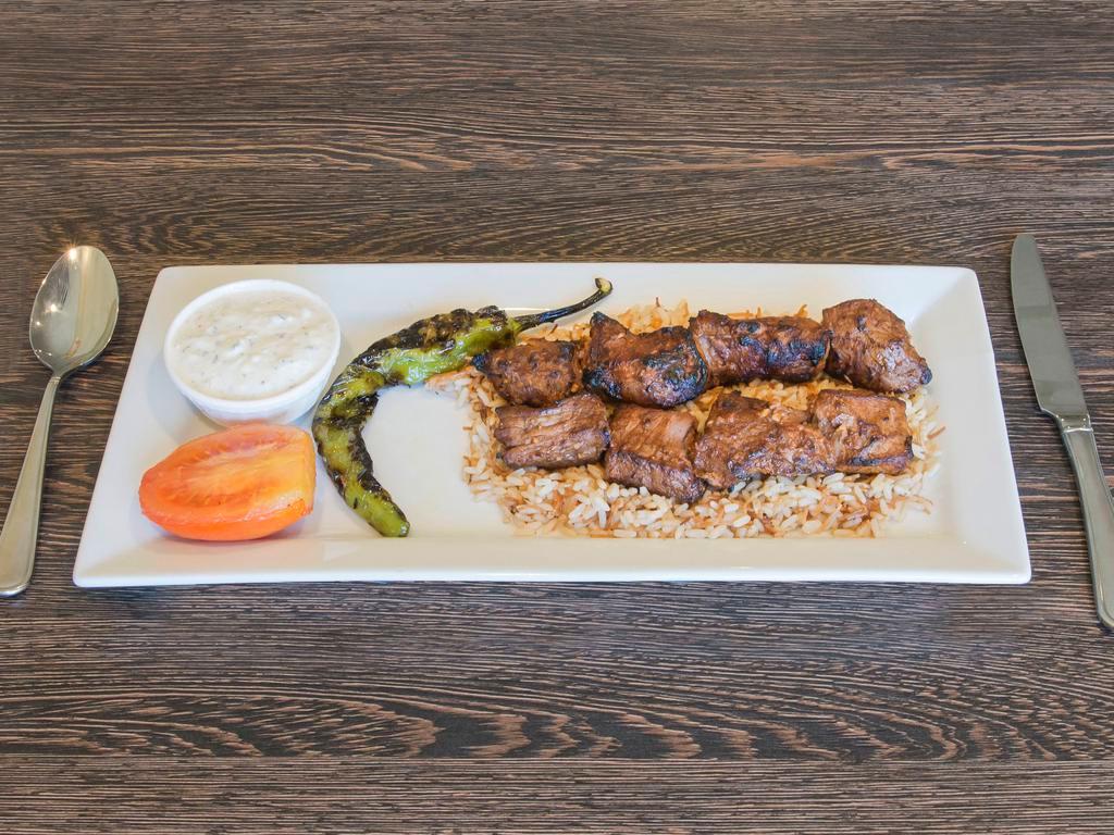 Shish Kebab · Char-grilled tender cubes of baby lamb marinated with our homemade seasoning.