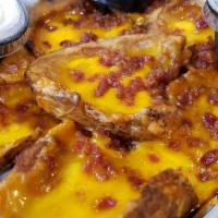 Potato Skins · Freshly made skins, stuffed with cheddar Jack cheese and smoked bacon. Baked and then topped...