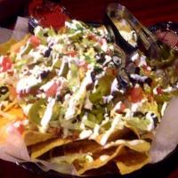 Camacho Nachos Large · Zesty, seasoned ground chuck piled over corn tortilla chips, topped with nacho cheese sauce,...