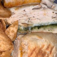 Turkey Pesto Panini · Sliced breast of turkey with sun dried tomato and basil pesto, topped with mozzarella cheese...