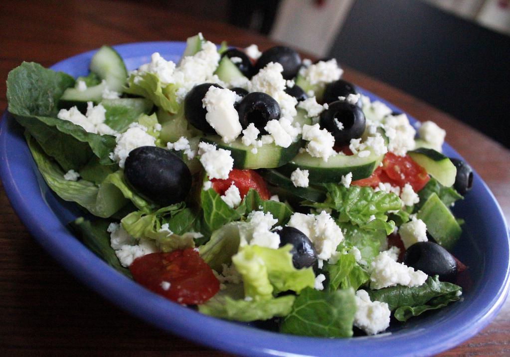 Greek Salad · Seasonal greens, hummus, olives, cucumbers, tomato, feta cheese, choice of dressing. Prepared cold.