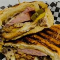 Cuban · Marinated roasted pork on our soft Cuban roll topped with Pit Ham, Dill Pickles. Bread and B...