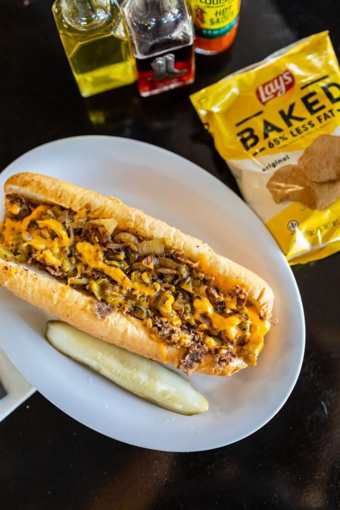 Philly Cheesesteak  · Shaved ribeye with grilled green peppers, grilled onions, cheddar cheese sauce, served on a Amoroso roll imported straight from Philadelphia