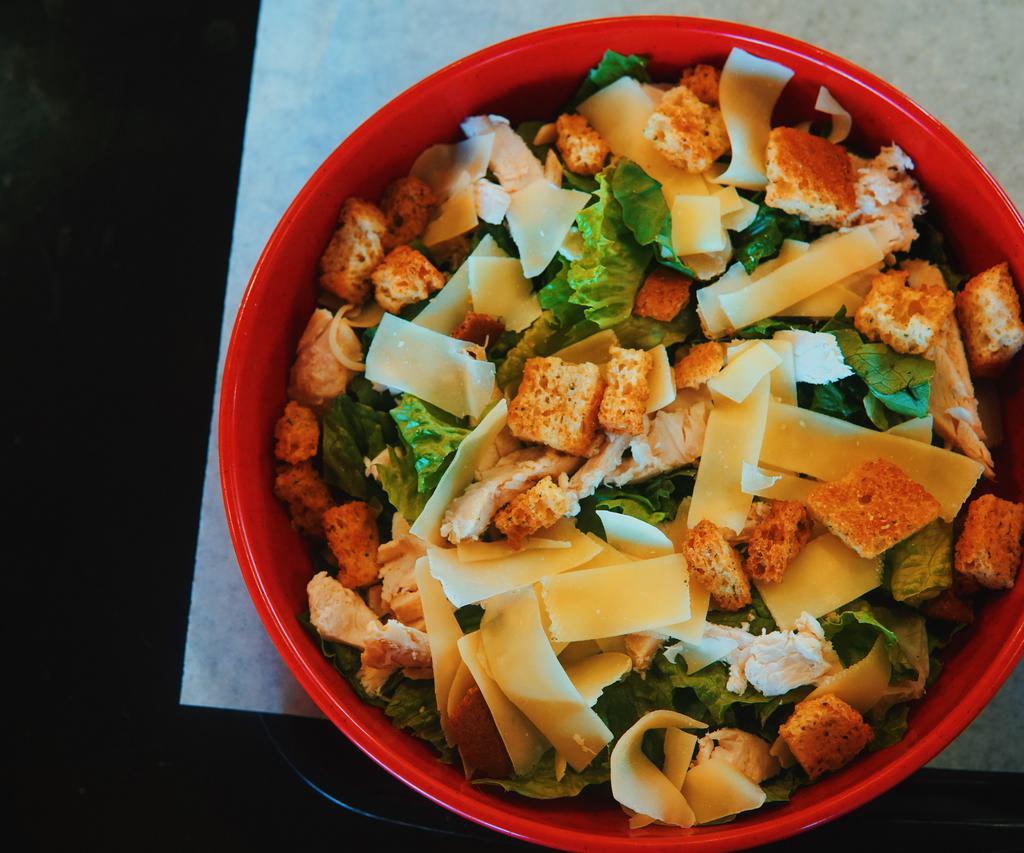 Caesar Salad with Chicken · Fresh Romaine lettuce, Shaved aged Parmesan cheese, tender honey marinated chicken, garlic and herb roasted croutons. 
