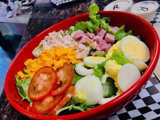 Chef Salad · Ham, turkey, lettuce mix, cheddar cheese, diced eggs, and tomatoes.