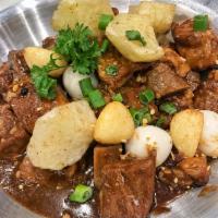 Pork Adobo · Pork stew braised in vinegar, soy sauce, garlic and onions.