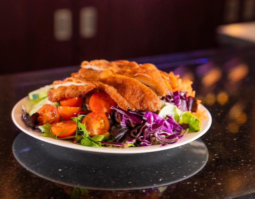 Schnitzel Salad · Mixed greens, cucumbers, tomatoes, onions, carrots topped with your choice of schnitzel. Served with your choice of dressing on the side.