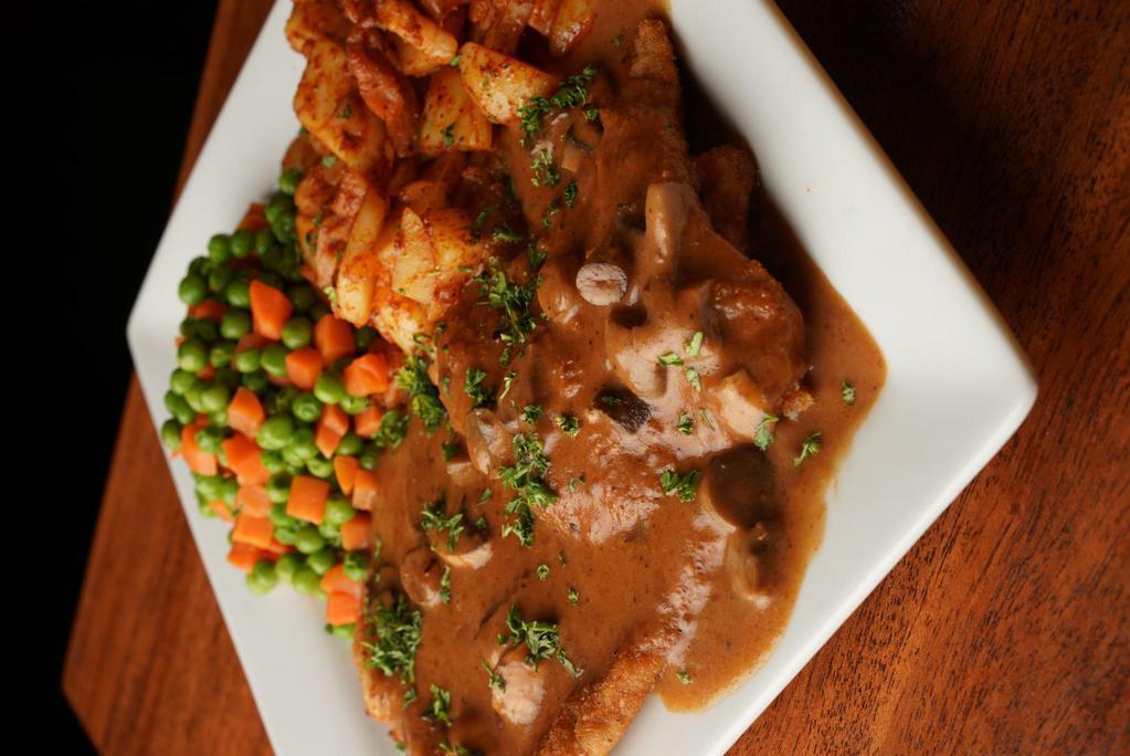Jäger Schnitzel · Our most popular dish. Seasoned cutlets, lightly breaded then crisped to a golden brown and topped with a creamy mushroom sauce. Our most popular preparation!!