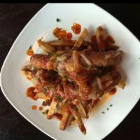 Currywurst Platter · 2 locally sourced Azar bratwurst topped with chef’s curry sauce and sauteed onions. Served w...