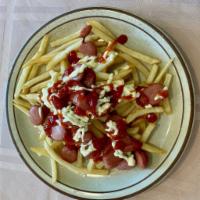 135. Salchipapas · Pieces of fried hot dog tossed over french fries, ketchup and mayonnaise on top
