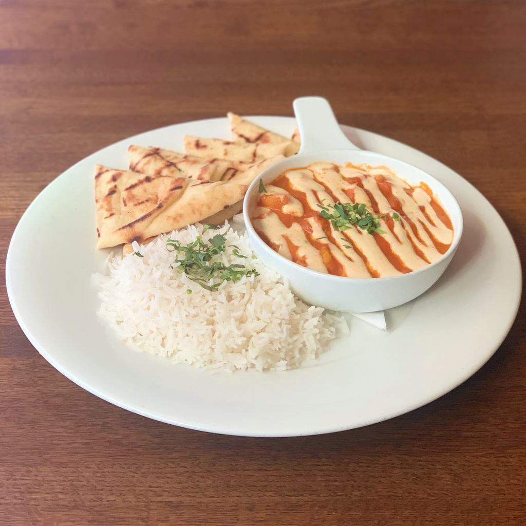 Manta's Butter Chicken · Curried tomato cream sauce with cashew butter topped with chopped cilantro and spiced yogurt. Served basmati rice and grilled garlic naan bread.