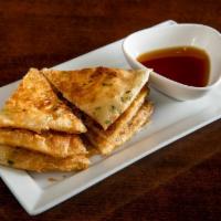 +Scallion Pancake · Not Spicy. Scallion pancake cut into eight pieces. Served w/ ginger soy sauce.