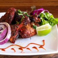 TANDOORI CHICKEN · 2 pieces. 2 grilled chicken leg-quarters marinated in a spicy yogurt sauce. Gluten free.