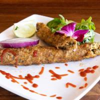 CHICKEN SEEKH KEBAB · Marinted chicken (minced in-house), infused with herbs, shah zeera and Indian spices.