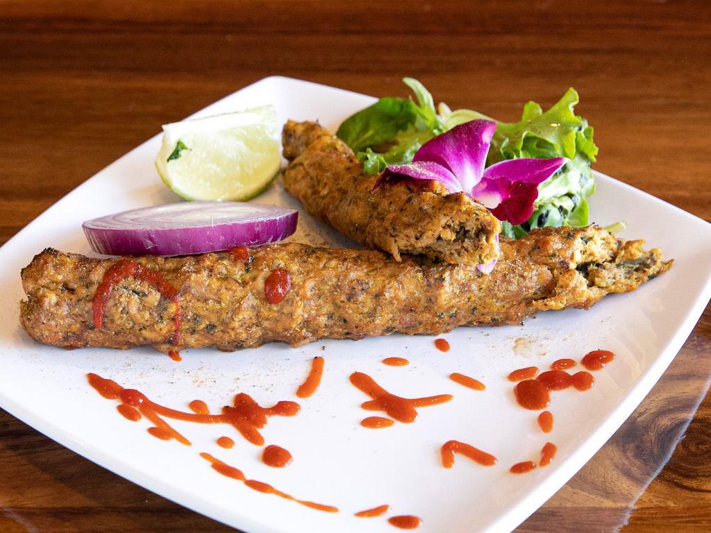 CHICKEN SEEKH KEBAB · Marinted chicken (minced in-house), infused with herbs, shah zeera and Indian spices.