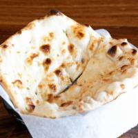 BUTTER NAAN · Butter-infused, teardrop-shaped, leavened bread baked in a tandoor oven.