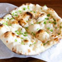 CHILI NAAN · Chili-infused, teardrop-shaped, leavened bread baked in a tandoor oven.