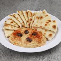 Hummus · House-made hummus finished with black olives and extra virgin olive oil drizzle. Served with...