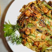 Seafood Pancake 해물파전 · Crispy pancake with scallions, onions, shrimp, mussels, and squid.