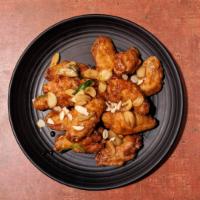 Garlic Fried Chicken Wings 갈릭치킨 · Fried chicken wings smothered in a glaze of soy-based sauce and topped with sliced garlic to...