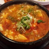 Kimchi Jjigae 김치찌개 · Spicy stew with matured kimchi, tofu, pork, onions, and garlic in veggie broth.