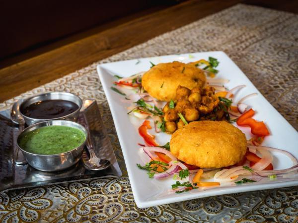 Delhi Aloo Tikki · Potato cutlet topped with tamarind and mint chutney, a street food favorite.