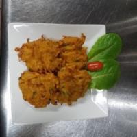 Mixed Vegetable Pakoras · A savory assortment of deep fried spinach, potato and onion in a Bengal gram flour batter.