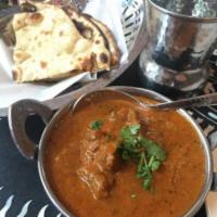 Mughlai Roghan Josh · A delicacy of Kashmiri, spicy and bold flavors of whole spices goat curry.