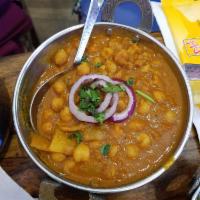 Channa Masala · Village style chickpeas cooked in brown onion and whole spices.