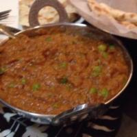 Baigan Bhartha · Roasted eggplant cooked with onions and peas.