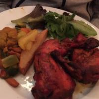 Tandoori Chicken · Roasted chicken prepared with yogurt and spices in a clay oven.