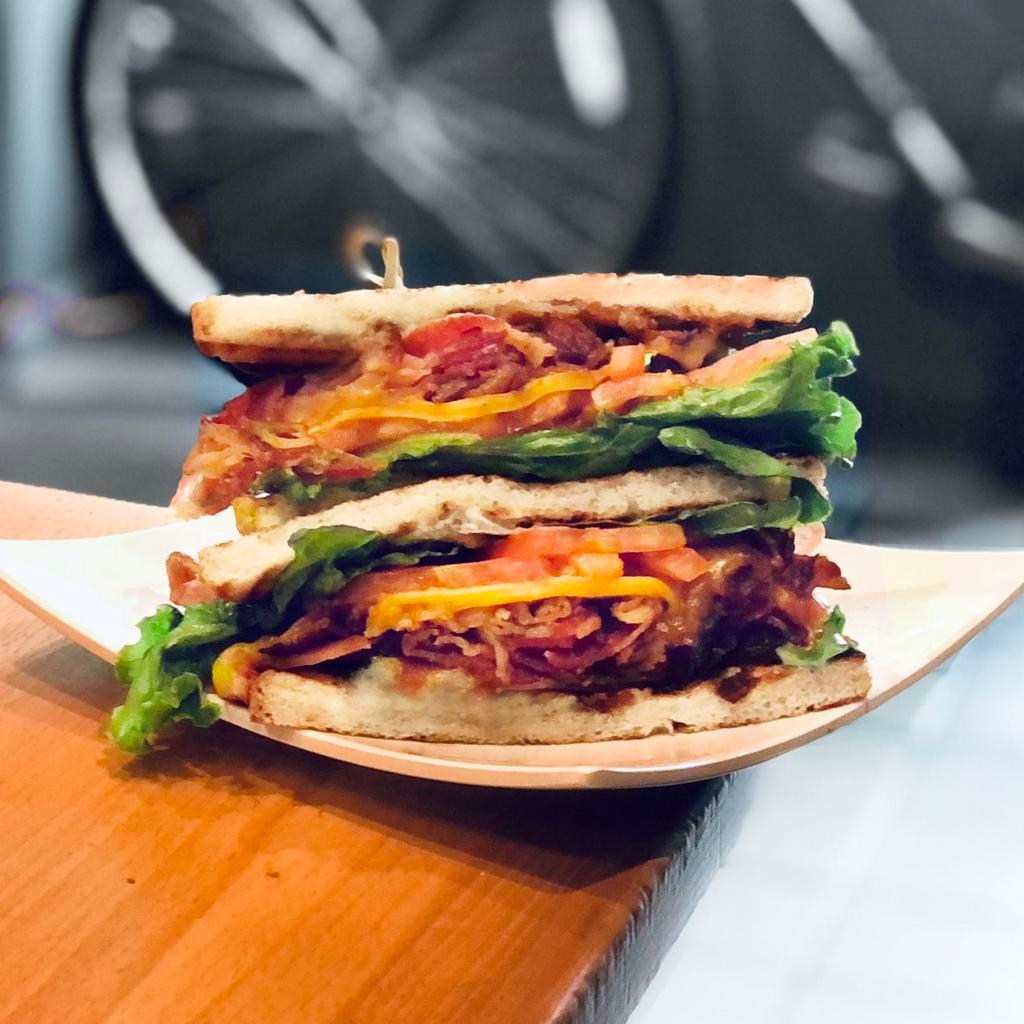 Monster BLT Sandwich · Thick-cut bacon, avocado, smoked cheddar, lettuce, tomato and Kewpie mayo on thick-cut white bread.