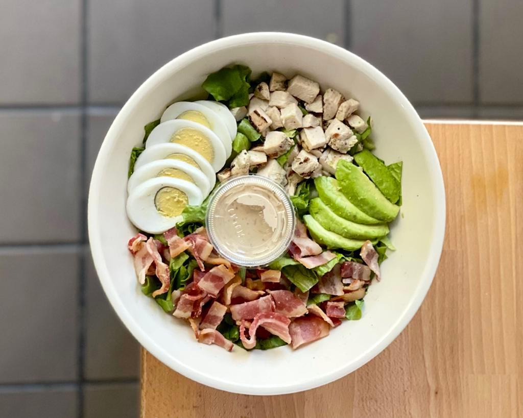 Classic Cobb Salad · Grilled chicken breast, chopped bacon, avocado and hard-boiled egg over lettuce.