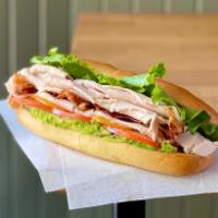 Turkey Club Sandwich · Turkey breast, bacon, cheddar cheese, lettuce, tomato, avocado, red onion and ranch on hero.