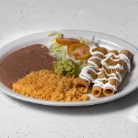 Flautas de Pollo · 3 crispy corn tortilla stuffed with chicken, served with rice, beans, salad, guacamole and s...
