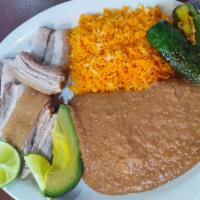 Carnitas de Puerco · Served with rice, beans and guacamole salad.
