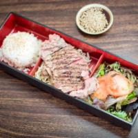 4. Salmon Teriyaki Bento Box · Grill salmon with teriyaki sauce, sesame seeds, rice and salad.