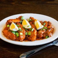 Chicken 555 · Boneless chicken pieces made with a variety of South Indian spices, topped with boiled eggs.